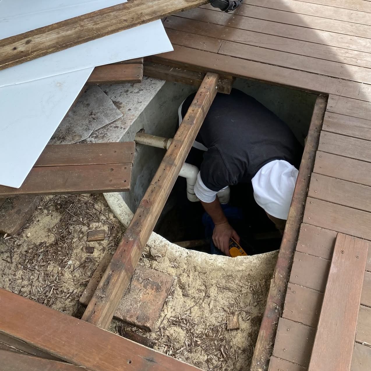 James working in a bore chamber beneath a lifted timber deck