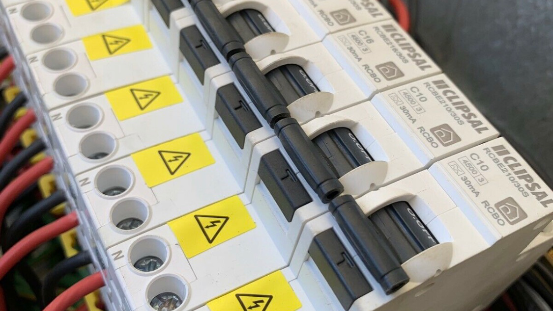 Row of Clipsal RCBO safety switches wired into a switchboard